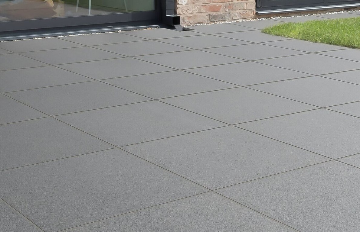 Smooth brushed gray concrete pool deck with clean control joints at a residential property in Little Rock, AR